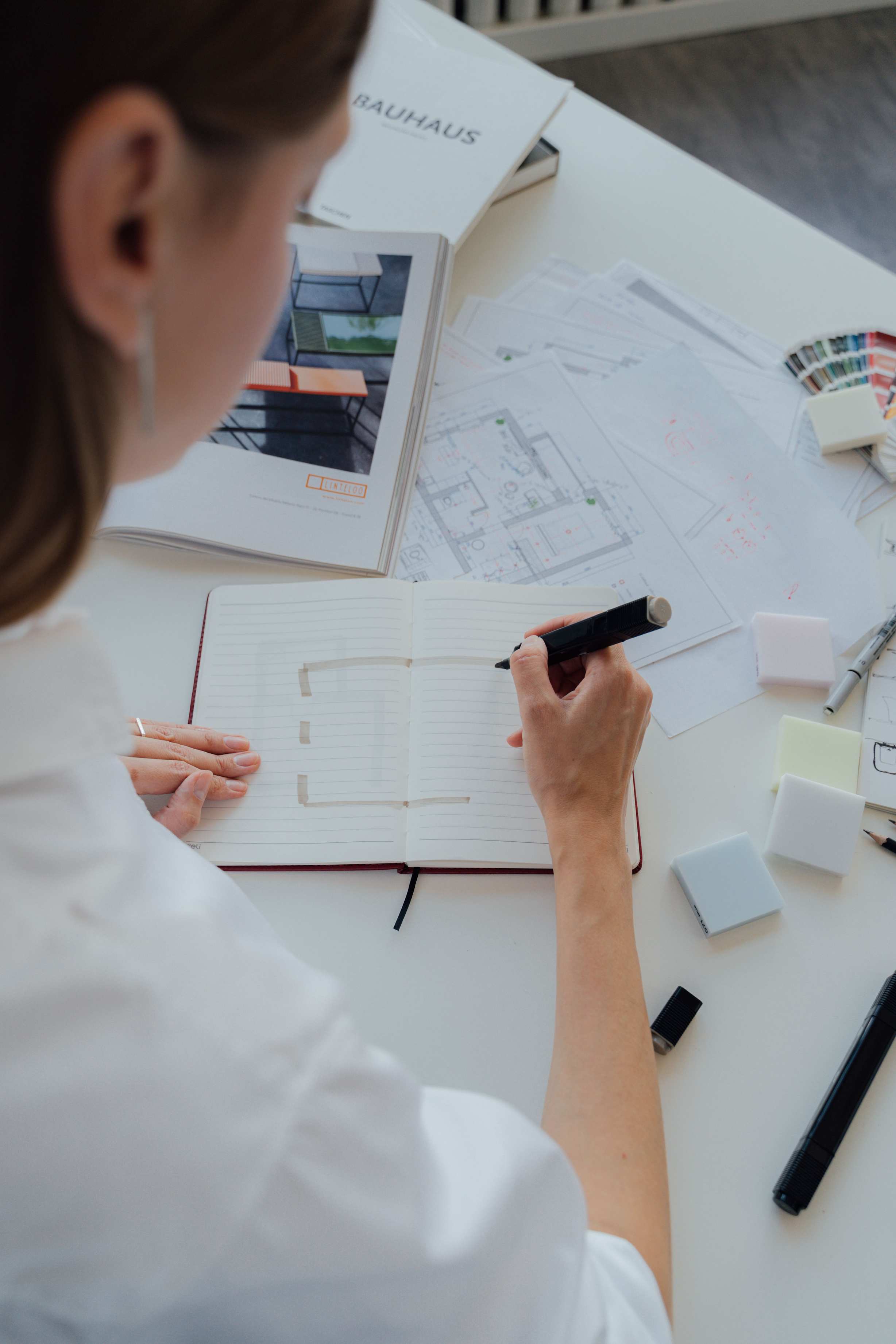 Planning session with floor plan sketch and architecture materials on desk